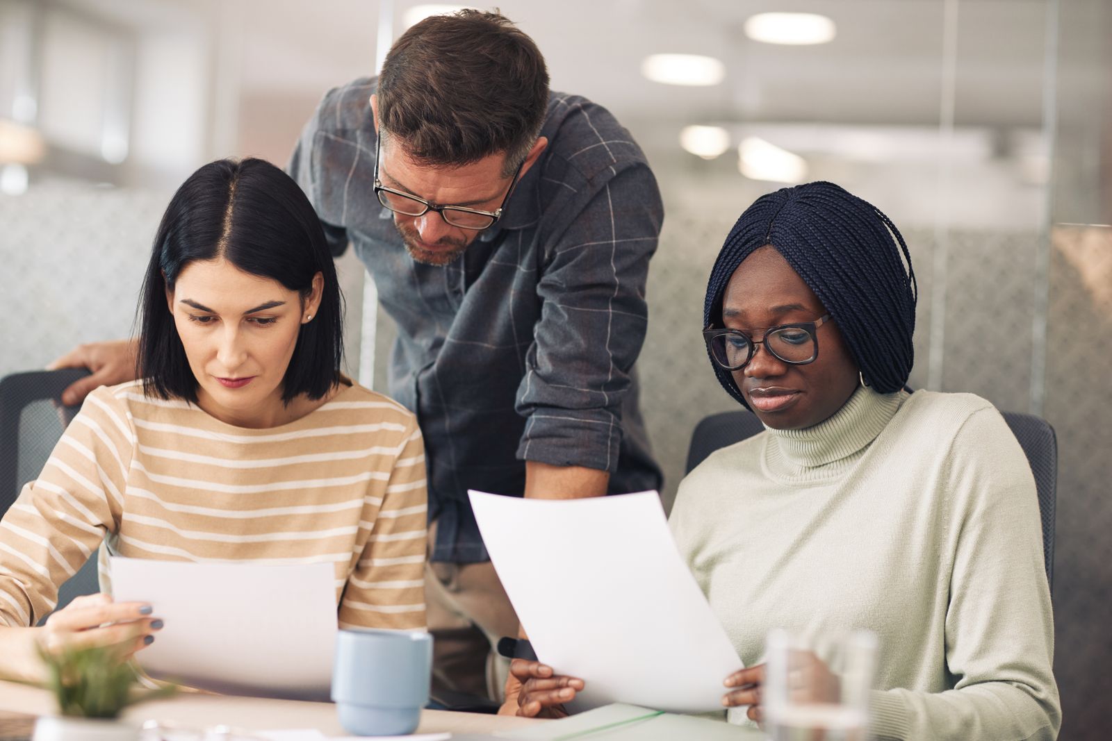 A diverse professional team reviewing quality documents together