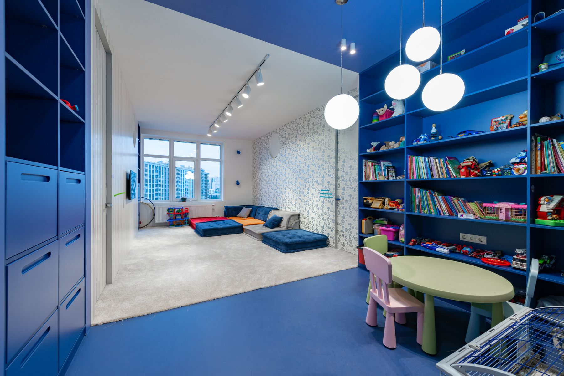 A bright, welcoming playroom with books, toys, and child-sized seating
